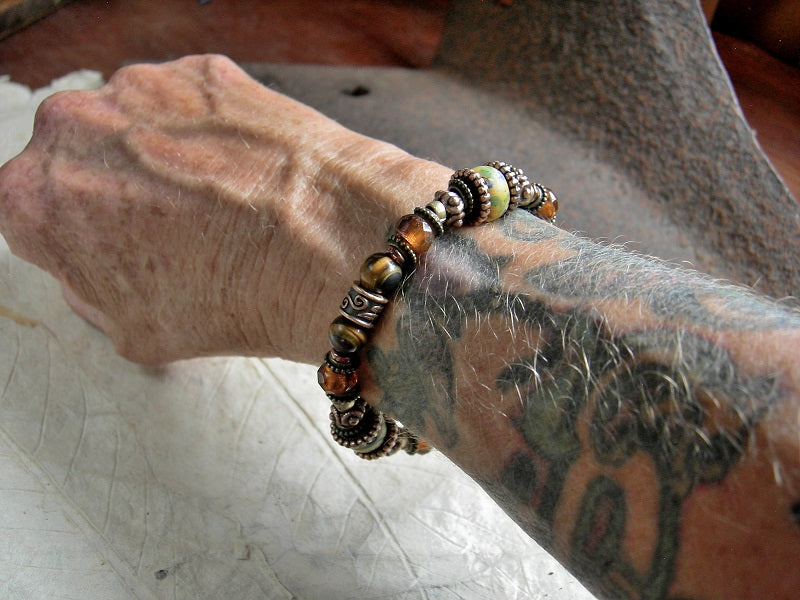 Warm color adjustable slider bracelet with antique Venetian glass, tiger eye, amber-orange faceted Czech glass & copper. 