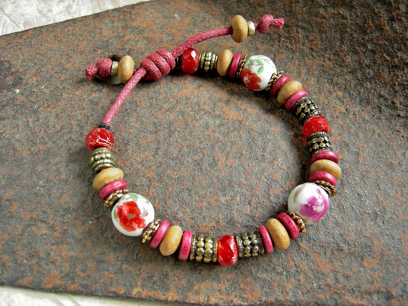 Brass & red adjustable slider bracelet with vintage porcelain beads, sandalwood & Greek ceramic discs, faceted glass beads.