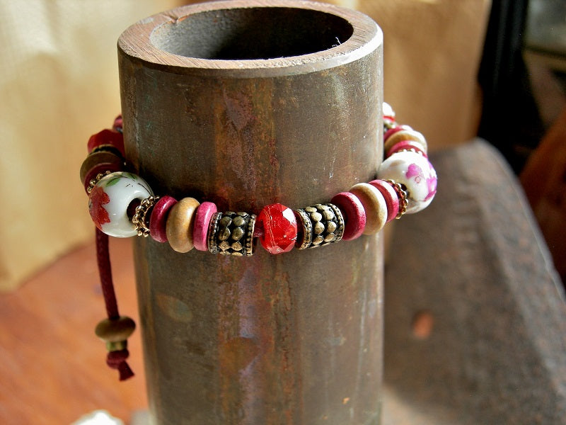 Boho adjustable slider bracelet with vintage porcelain beads, sandalwood & Greek ceramic discs, faceted glass beads. Brass & red.