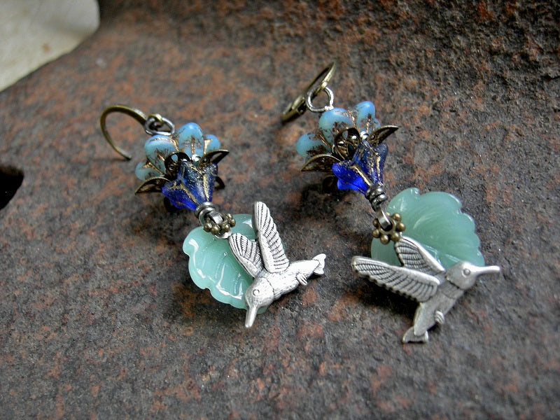 Blue Morning earrings with silvery little hummingbirds,  blue glass flowers, pale green glass leaf beads & antiqued brass and silver details. 