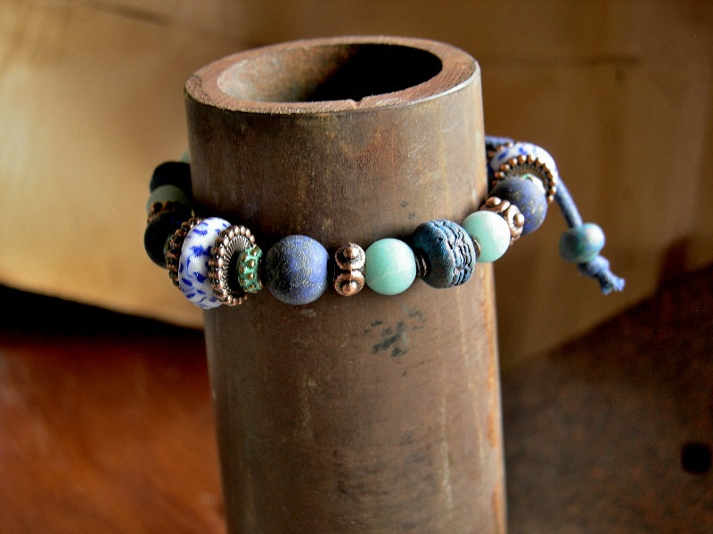 Blue gemstone adjustable slider bracelet with lapis, amazonite, copper, glass & ceramic beads. 