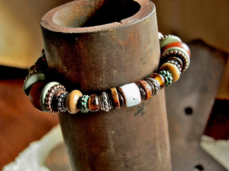 Adjustable slider bracelet in earthy amber & turquoise colors with silver, copper wood & ceramic.