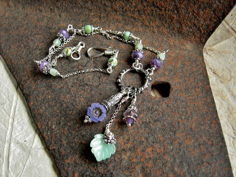 Dainty short length silver chain necklace with purple & green gemstone and glass flower & leaf beads. 