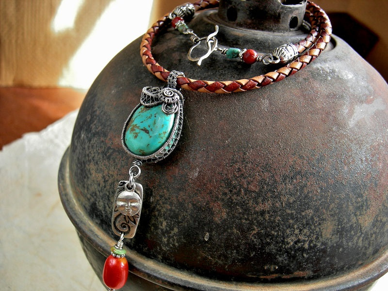 Boho luxe turquoise & sterling wire wrap necklace, on braided leather bolor cord, with coral beads & silver charms. 