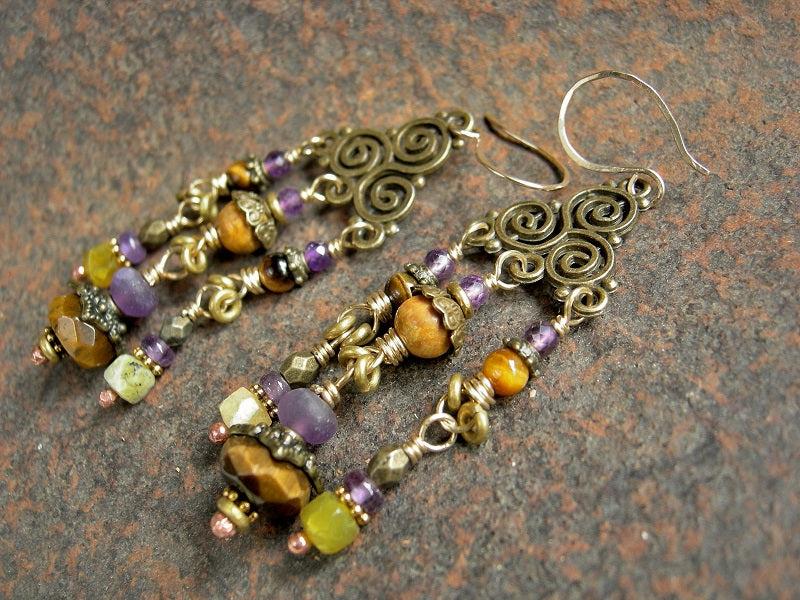 Brass triskelion chandelier earrings with amethyst, tiger eye, yellow opal & fossilized coral gemstone beads. 14kt gf ear wires. 
