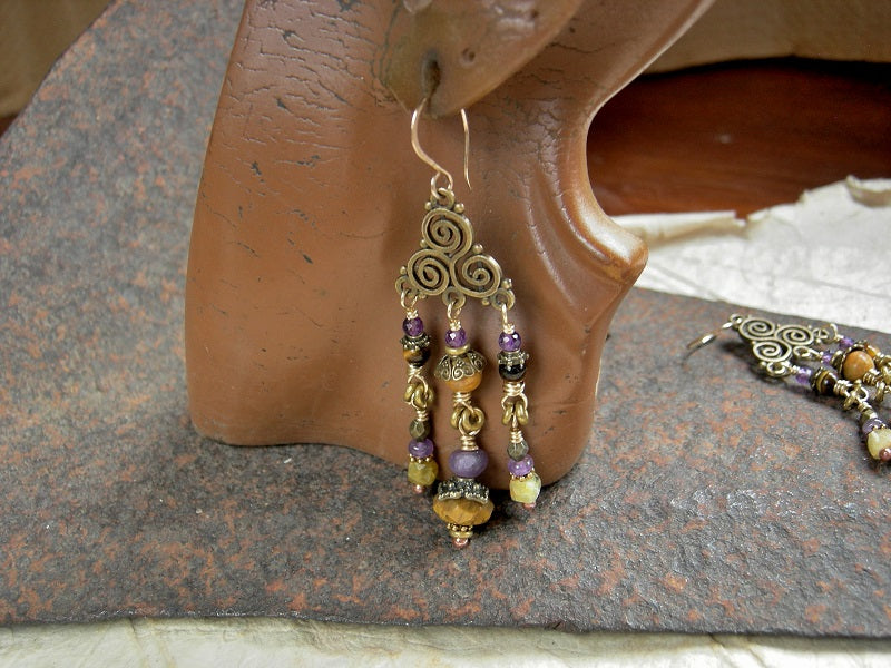 Triple spiral chandelier earrings in antiqued brass with amethyst, tiger eye, yellow opal & fossilized coral gemstone beads. 14kt gf ear wires. 