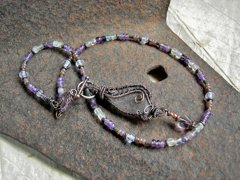 Stung bead style necklace with sea glass "wing" & copper wire wrap focal, amethyst, fluorite & copper beads. 