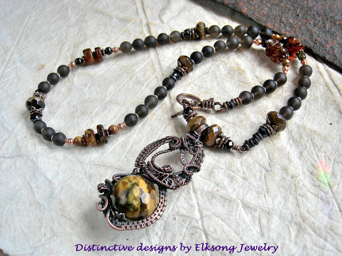 Tiger eye & copper wire wrap art necklace, with ornate focal & strung smoky quartz, tiger eye, black tourmaline & amber beads. 