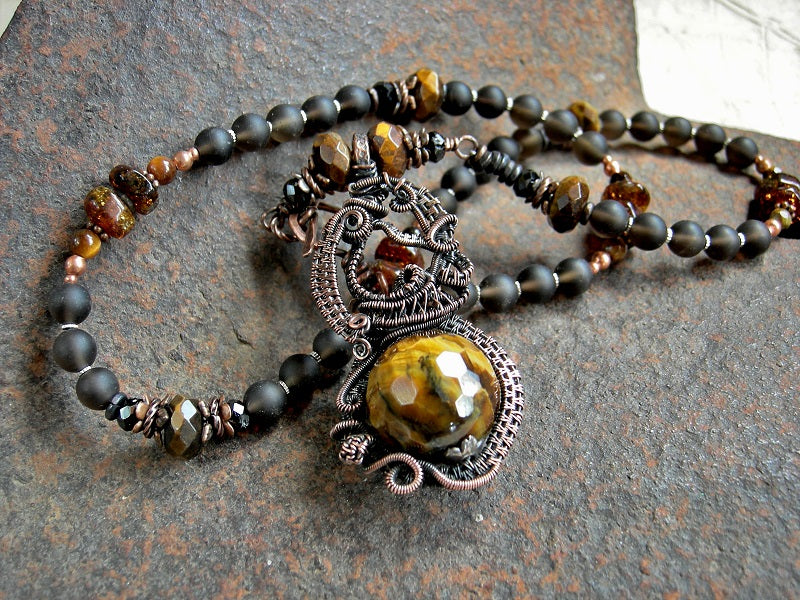 Opulent wire wrap art necklace, with ornate focal & strung smoky quartz, tiger eye, black tourmaline & amber beads. 