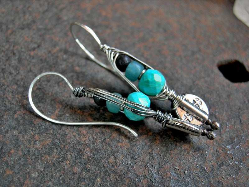 Sleek sterling wrapped hook earrings with turquoise, Java glass, black lava stone & oxidized sterling wire wrap. 