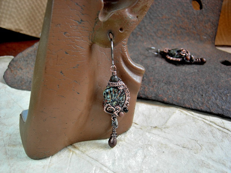 Black glass nautilus earrings with copper wire wrap, glass seed beads & drops and faceted black toumalinated quartz rounds. 