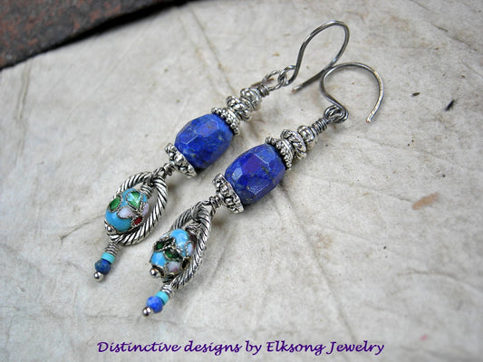 Blue beaded earrings with silver accents on a textured surface, featuring Elksong Jewelry branding.