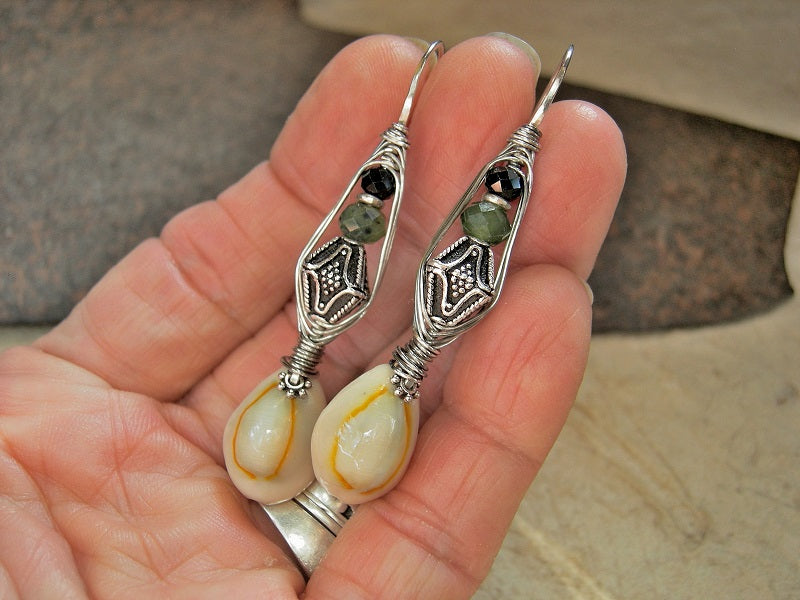Sterling wrapped hook earrings with faceted jade, black toumaline & Bali style sterling-over-copper bi-cone beads & natural cowrie shells. 