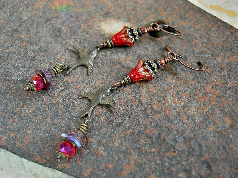 Long drop earrings with red glass flowers, antiqued  bronze bird connetors, antiqued brass & copper caps, faceted red crystal rondelles & lever back ear wires. 