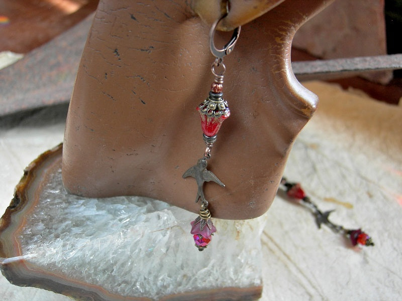 Scarlet glass flower & antiqued bronze bird charm earrings with antiqued brass & copper caps, faceted red crystal rondelles & lever back ear wires. 