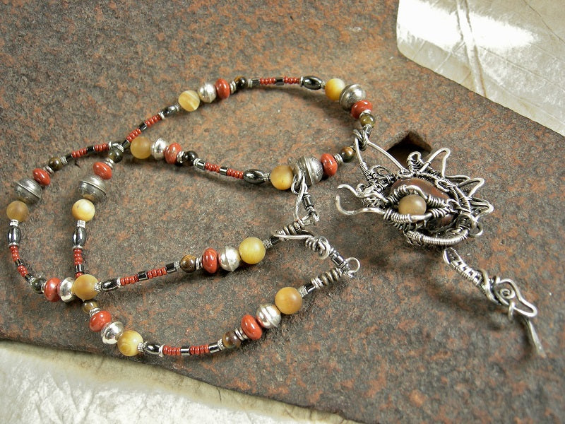 Strung bead statement necklace with sterling wire wrap dragon & tiger iron cabochon focal, red & gold gemstone, sterling bench beads.