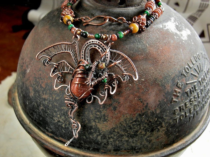 Strung bead necklace with copper wire wrap dragon focal, goldstone, green tiger eye, golden jade, copper caps & beads. 