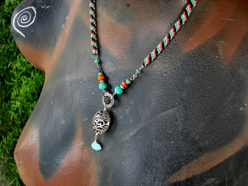 Woven seed bead necklace in turquoise, coral & black with turquoise & coral gemstone beads & silver filigree focal. 