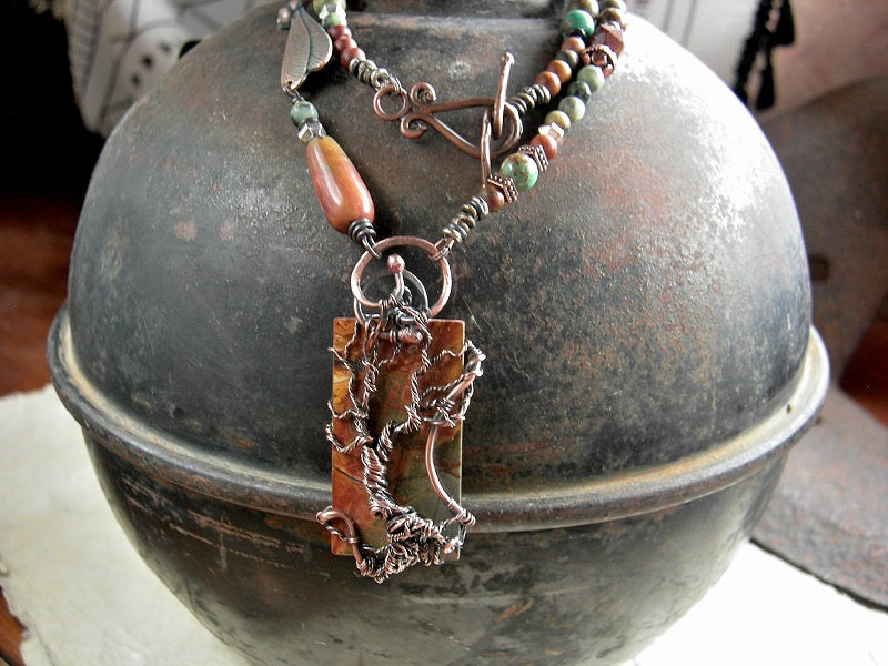 One of a kind necklace with Red Creek jasper & copper wire wrap tree focal, copper, jasper & turquoise beads & verdigris copper dragonfly connector. 