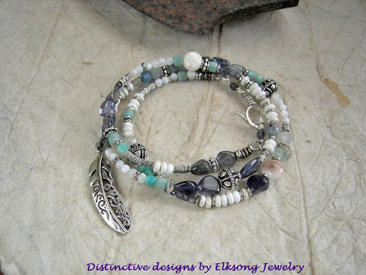 Fly Through the Storm wrap bracelet/necklace with blue & white gemstone beads, mother of pearl, sterling-over-copper beads, feather charm & sterling toggle clasp. 