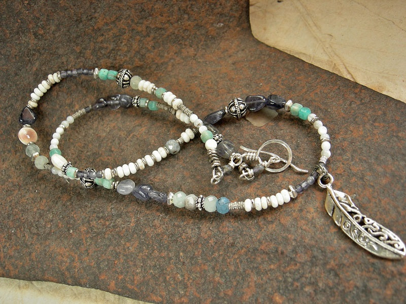 Strung bead necklace or wrap bracelet with blue & white gemstone beads, mother of pearl, sterling-over-copper beads, feather charm & sterling toggle clasp. 