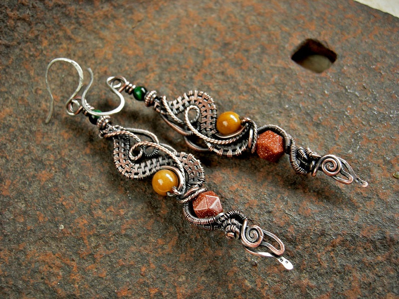 Curvy copper wire wrap earrings with dragon tail ends, green tiger eye, goldstone & golden jade beads. Sterling ear wires. 