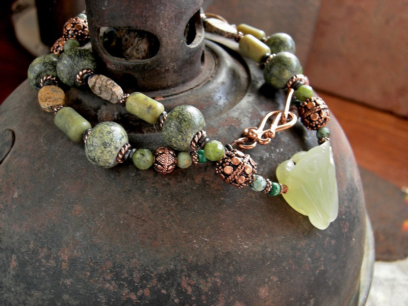 Boho elegant strung bead necklace with hand carved pale green serpentine frog focal, serpentine, jade, malachite,  jasper & copper beads. Copper toggle clasp.