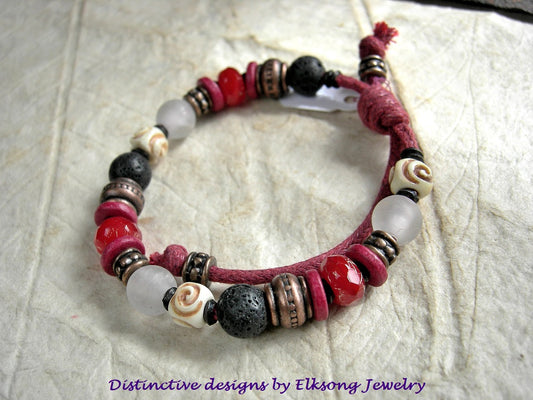 Adjustable sliding knot bracelet in bold black, white & red. Carved bone, stone & glass beads on red cord. 