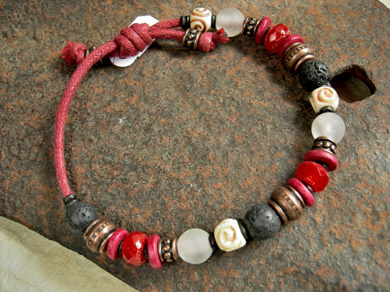 Sliding knot adjustable bracelet in bold black, white & red. Carved bone, quartz, lava stone, ceramic & glass beads on red cord.