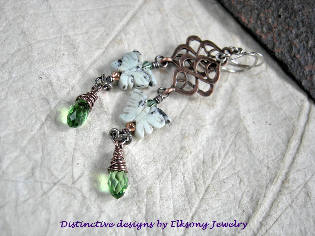 Long drop earrings with copper hangers, pale green stone butterfly beads & faceted green crystal.