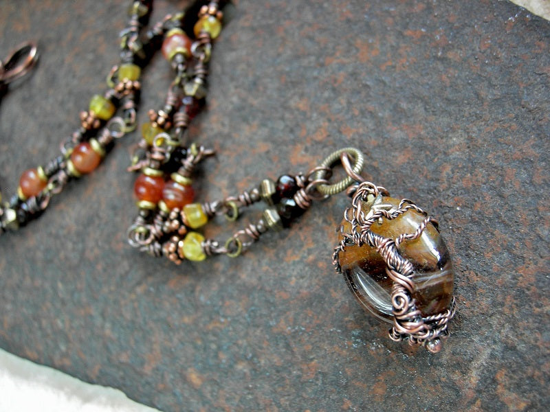 Wrapped link necklace with copper tree, copper & antiqued brass beads, amber nuggets & faceted rounds & carnelian. 
