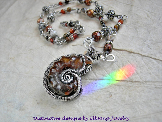 Fossilized Honey sterling wire wrapped ammonite necklace. Beaded sterling wrapped links with faceted amber, colored freshwater pearl, brown agate & tiger eye.   