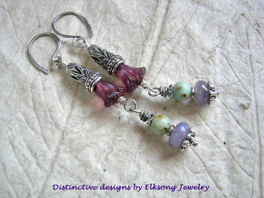 Long drop earrings with purple glass flowers, ornate silver cones, green & purple gemstone & sterling ear wires. 