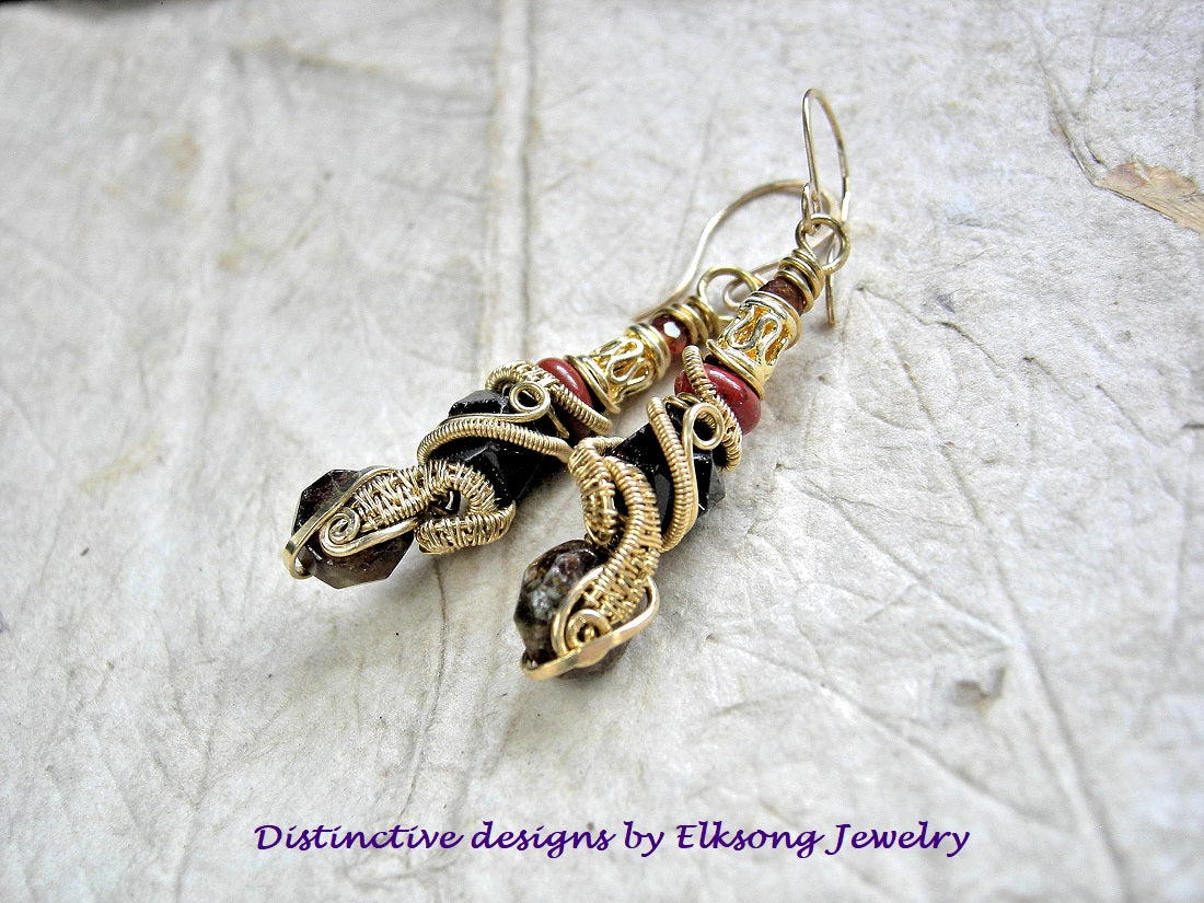 Golden brass wire wrap and red gemstone earrings on a textured white background with 'Elksong Jewelry' branding.