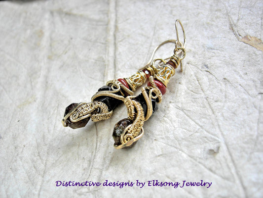 Golden brass wire wrap and red gemstone earrings on a textured white background with 'Elksong Jewelry' branding.
