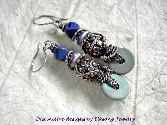 Pair of beaded earrings with blue lapis & copper wire wrap, featuring 'Distinctive designs by Elksong Jewelry'.