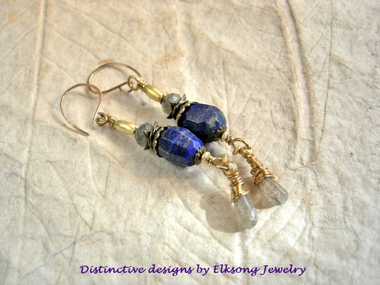 Pair of earrings with blue gemstone &* gold beads, featuring 'Distinctive designs by Elksong Jewelry'.
