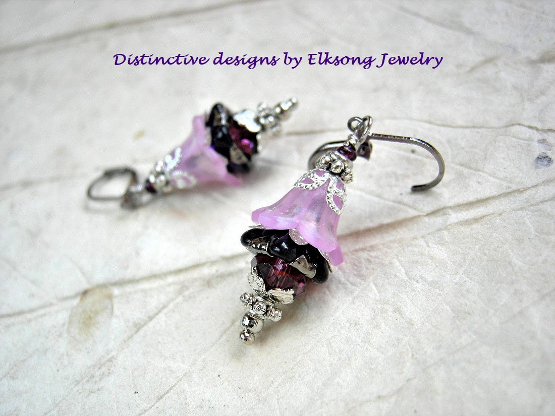 Flower nymph earrings in delicate purple resin flowers, dark amethyst glass flowers & silvery details. 