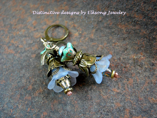 Double flower earrings in shades of blue with resin & glass flowers, faceted glass & crystal and antiqued brass. 