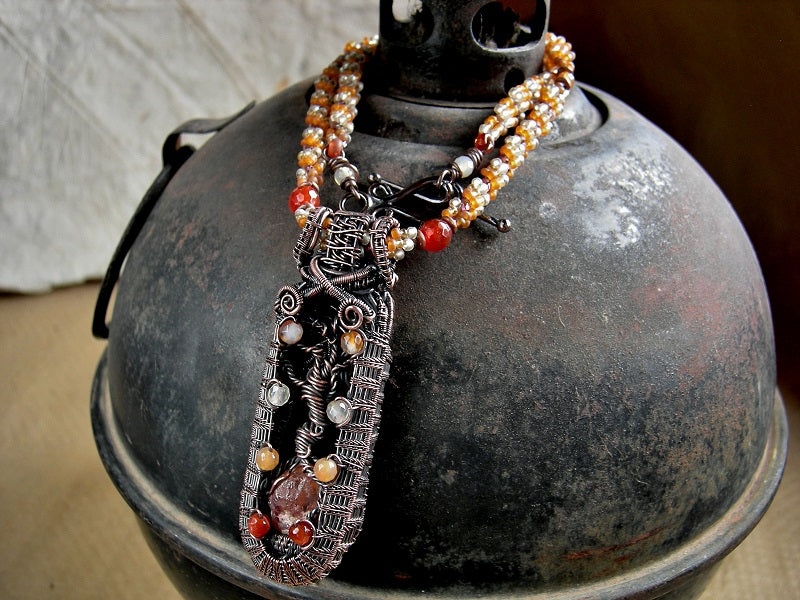 Copper tree one of a kind necklace with wire wrapped tree & faceted carnelian focal, woven seed bead rope necklace. Shades of orange & copper. 
