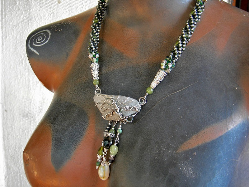 One of a kind sterling wire wrap tree necklace with woven seed beads, genuine sea glass & green gemstone beads.