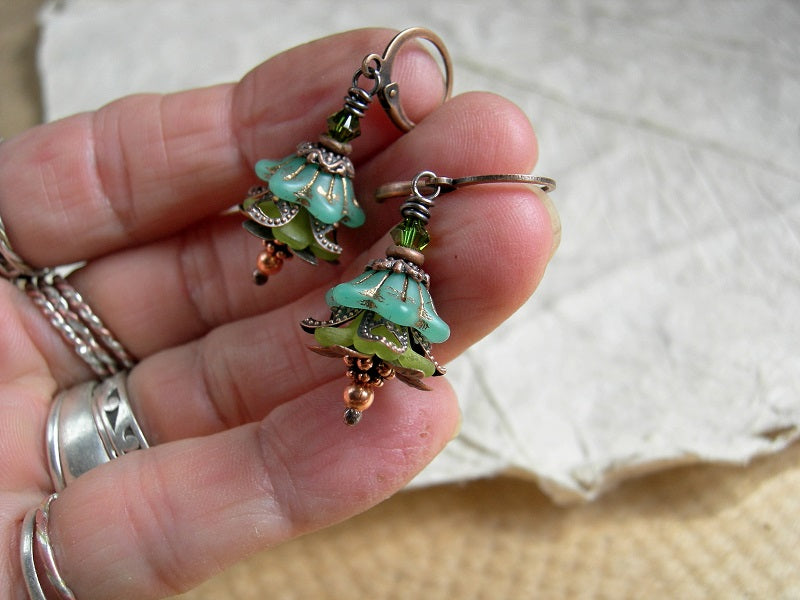 Faery couture flower earrings with green glass & resin flowers, copper caps & beads and Swarovski crystals. 