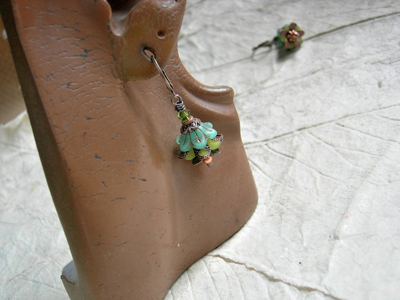 Green & copper earrings with glass & resin flowers, copper caps & beads and Swarovski crystals. 