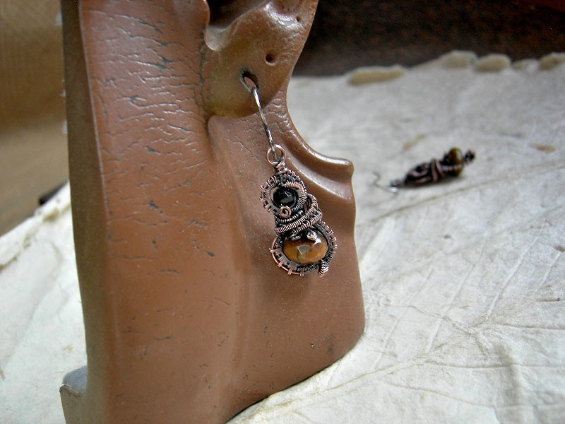 Lush, autumn color earrings with faceted tiger eye & black tourmaline and oxidized copper wire wrap. 
