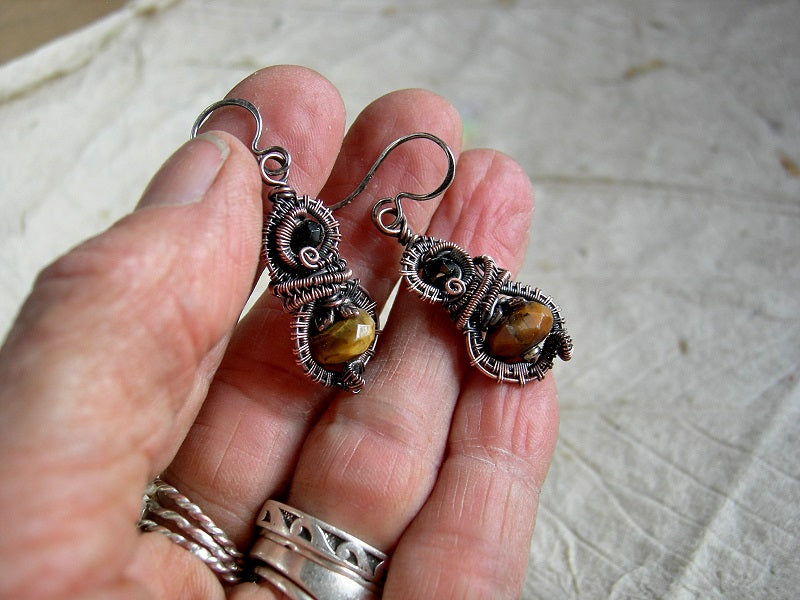 Boho luxe, autumn color earrings with faceted tiger eye & black tourmaline and oxidized copper wire wrap. 