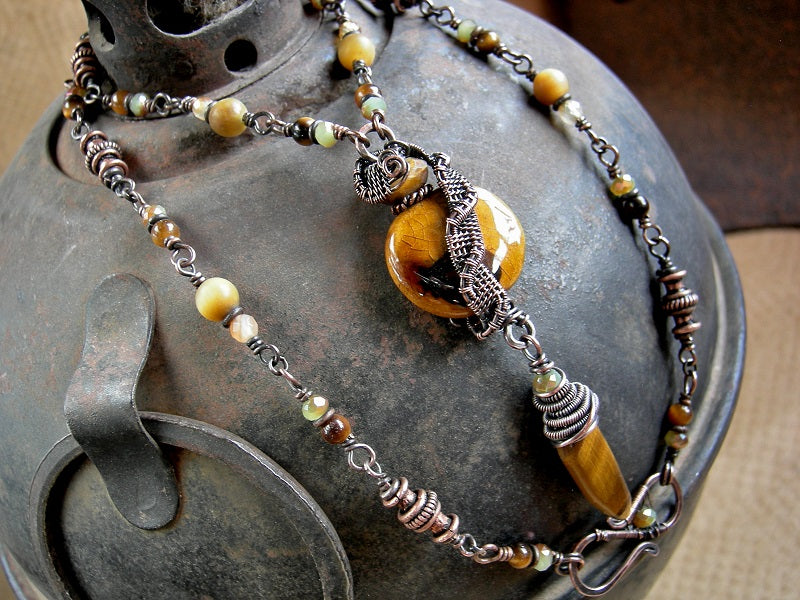 Necklace with autumn color gemstone, crystal & copper beads, oxidized copper wire wrap & ceramic bead focal. 