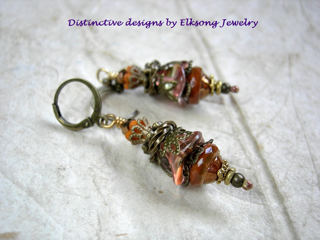 Persimmon drop earrings with glass flowers & faceted glass beads. Antiqued brass filigree & leverback earwires. 