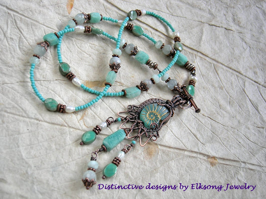 Ocean Spirit necklace with glass nautilus & copper wire wrap focal, aqua gemstone & seed beads and front facing toggle clasp.
