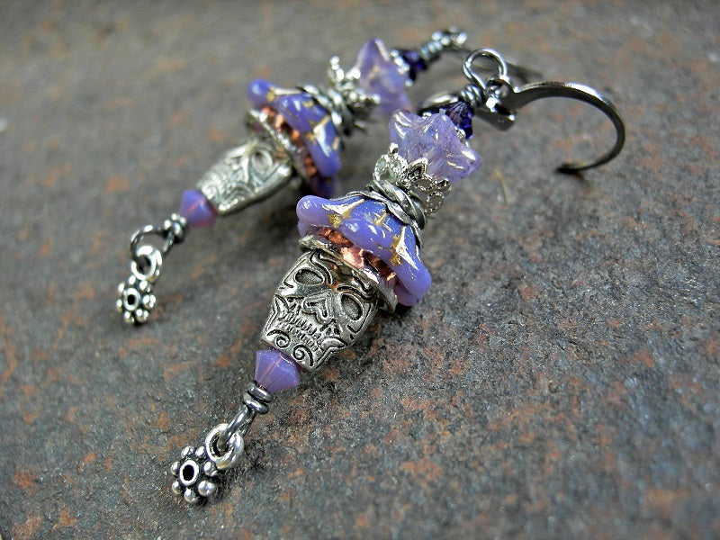 Boho sugar skull earrings with lavender glass flowers, silver metal skull beads & Swarovski crystals. 