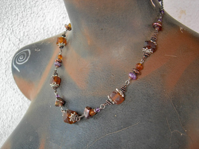 Maple sugar color necklace with natural amber, purple gemstone, recycled glass & keshi pearls. Oxidized copper wire wrap links. 
